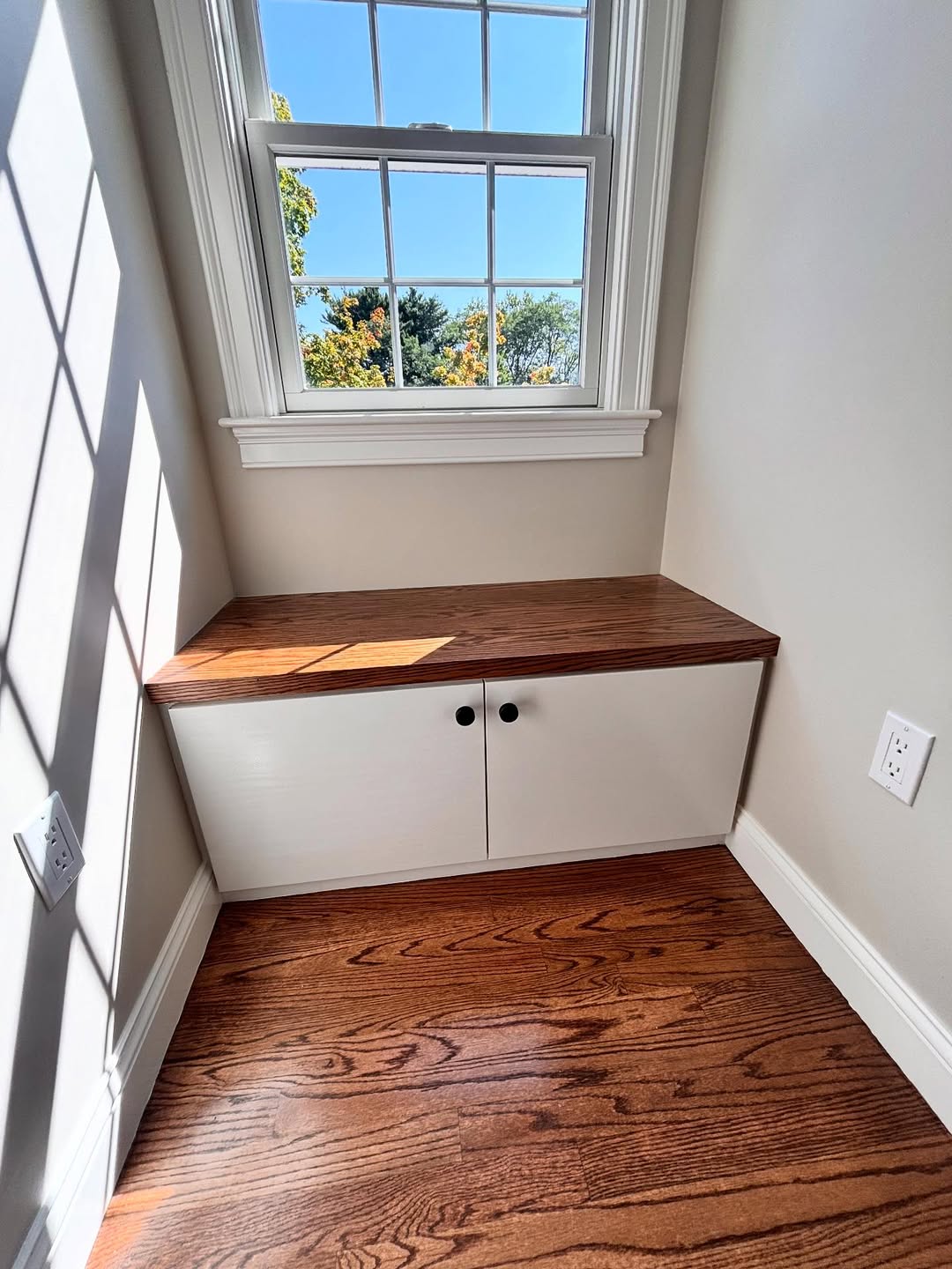 Window nook with stained oak top and white shaker cabinet