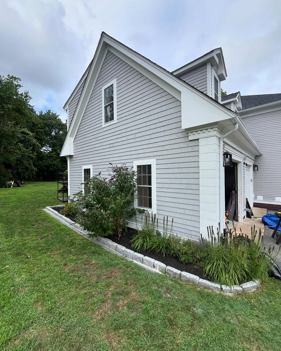 Rear elevation — new siding, gutters and white trim finish